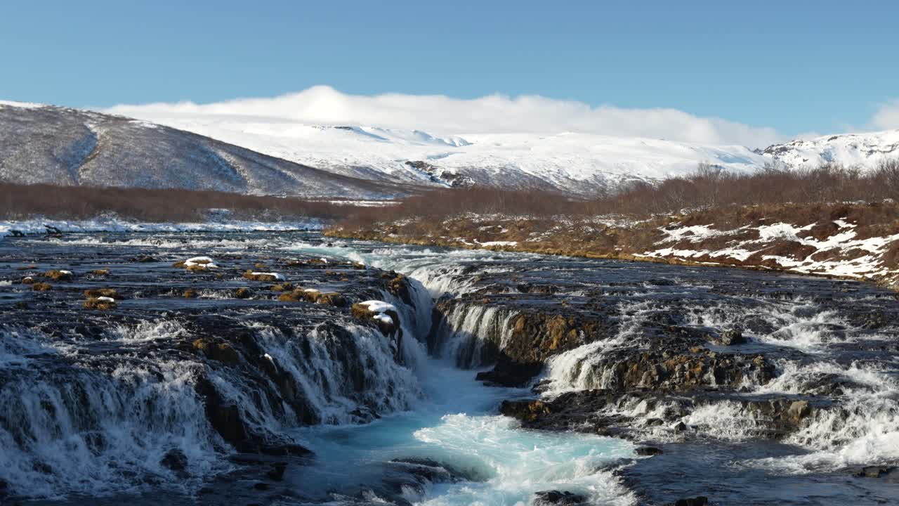 Brúarfoss waterfall in the Haukadalur valley near Laugarvatn, Iceland. Known for its vivid blue waters cutting through dark volcanic rock, this unique cascade.