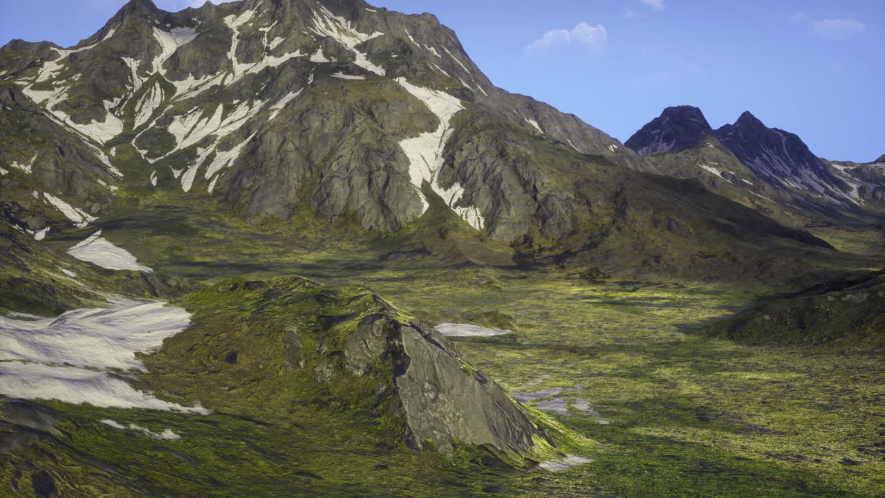 Majestetiske fjell og frodige, grønne daler under en klar, blå himmel