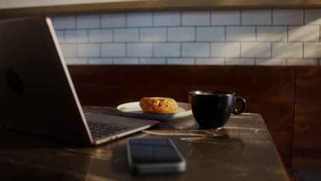 laptop, coffee, and pastry at a cafe