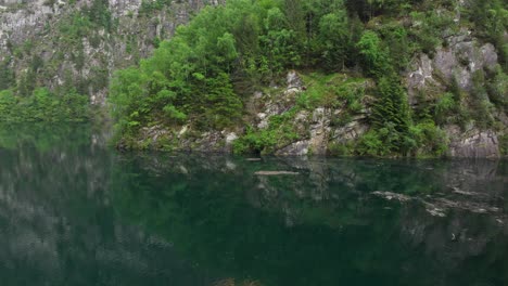 drone flying over surface water of malvaglia dam in switzerland