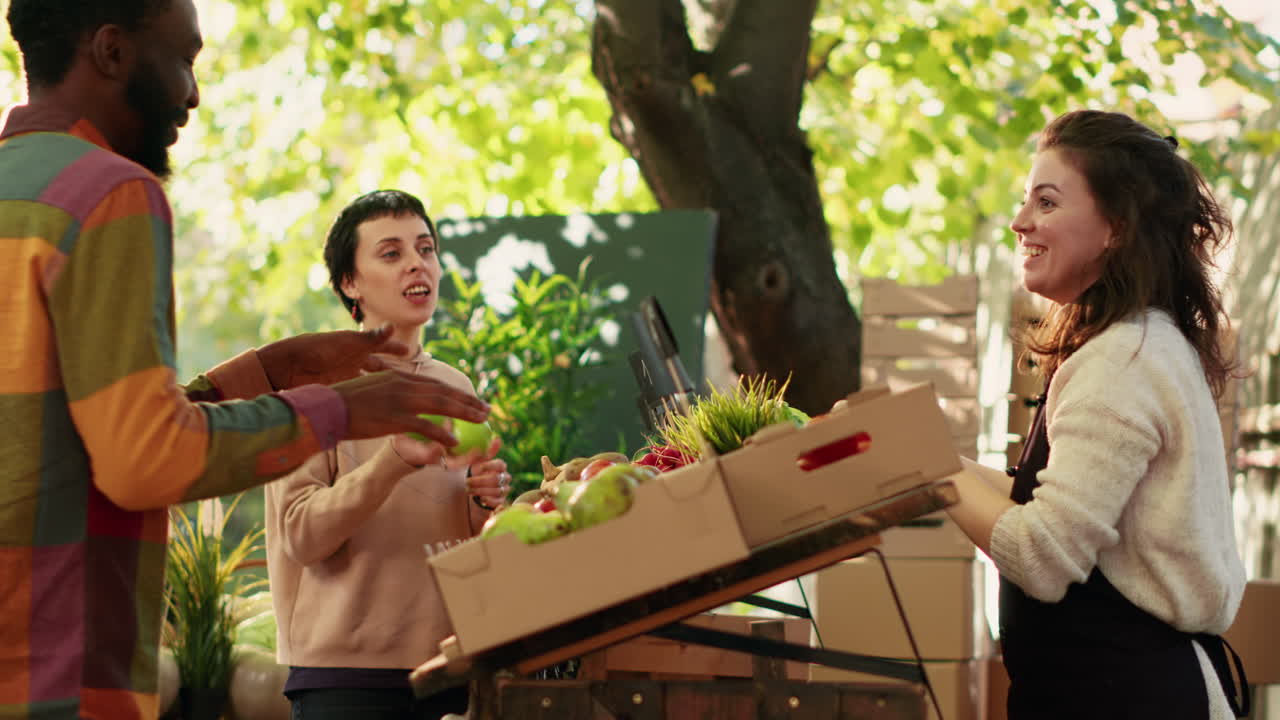 People at a market stall buying fruits and vegetables