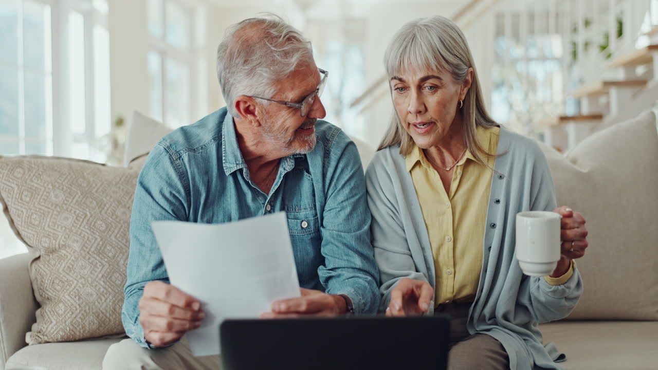 Senior couple reviewing finances at home