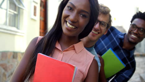 hipster students are smiling and holding copybook