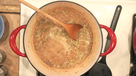 mixing the spices in a dutch oven before adding the chicken to roast in the sauce - overhead view pot roasted chicken series