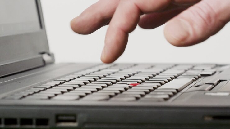 Someone typing a text on a laptop keyboard long version