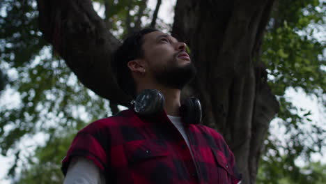 man with headphones in a park