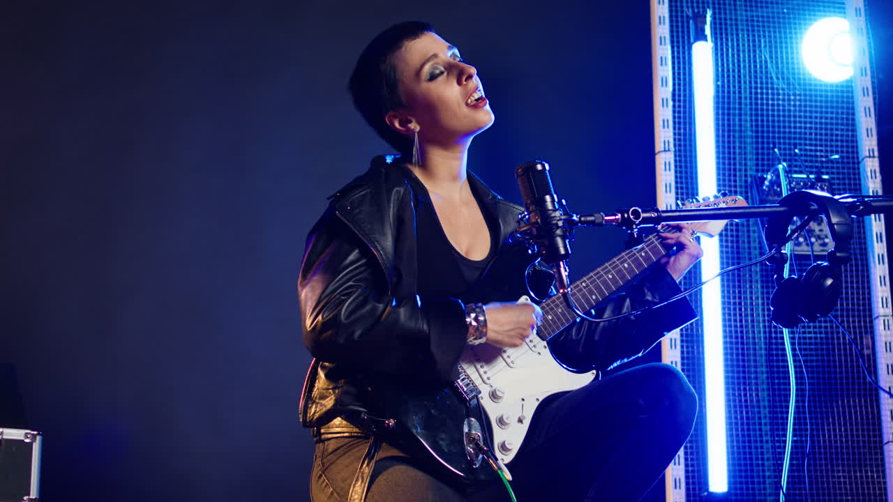 Female Guitarist Performing on Stage
