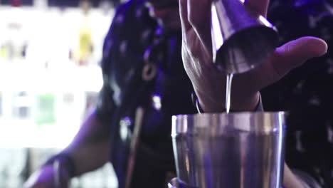 close-up detail of a elegant bartender pouring ounces