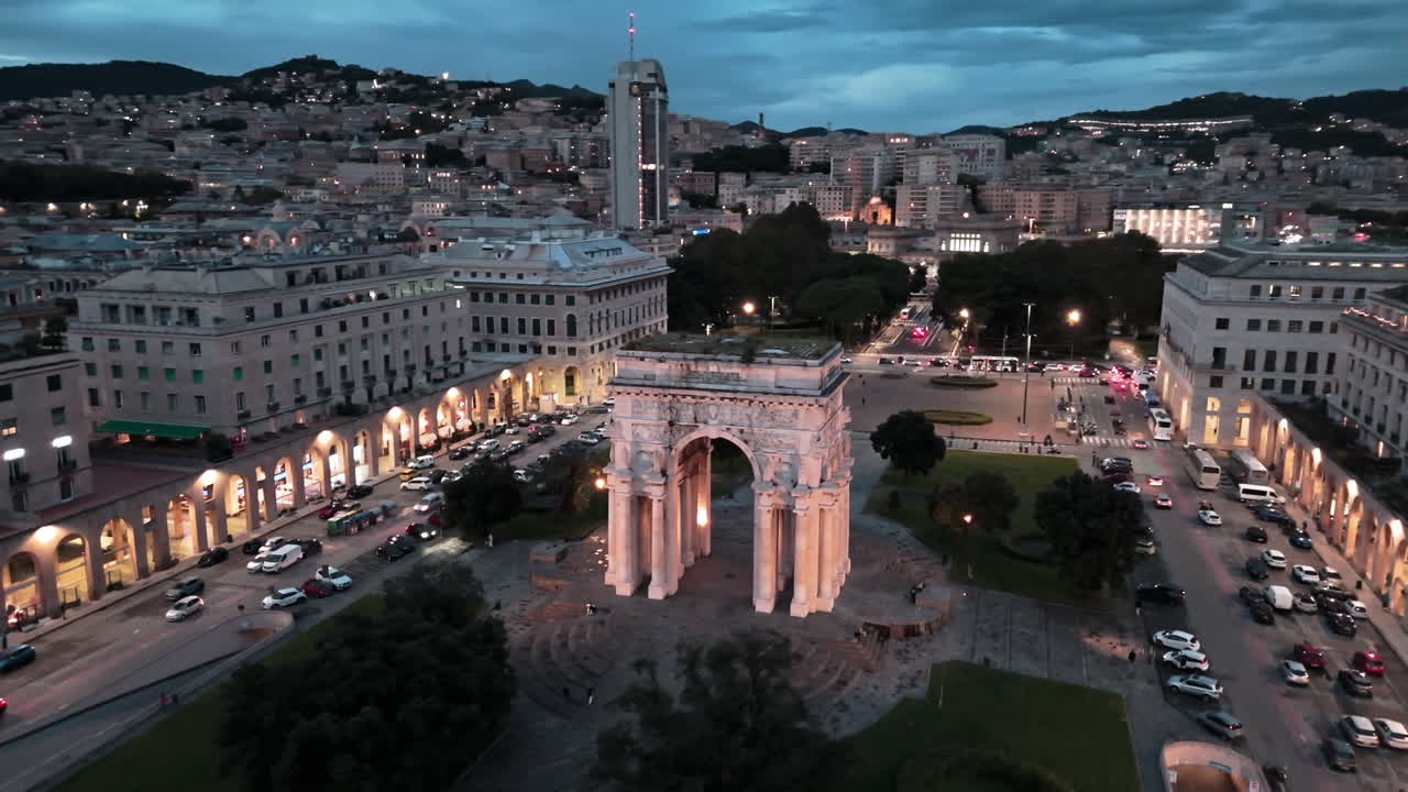 Twilight aerial view of lit up Arch of Victory on famous Piazza della Vittoria