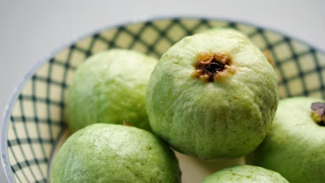 fresh green guavas in a bowl