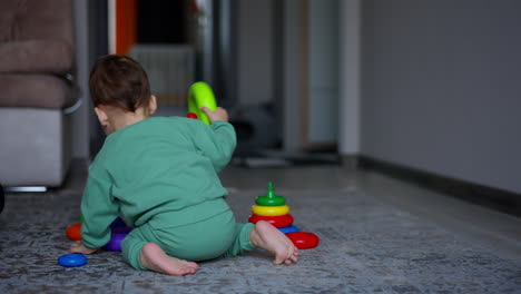 baby playing with stacking toys