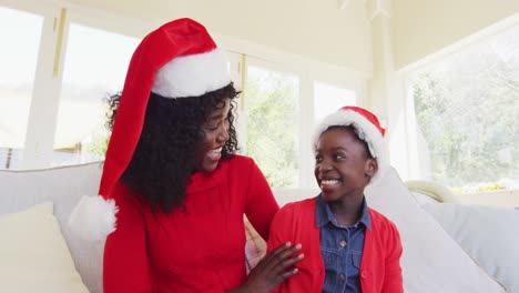 African-american-mother-and-daughter-smiling-and-waving