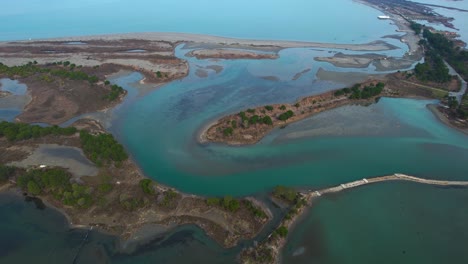 Colorful-shallow-waters-of-lagoon-on-coastline-of-Adriatic-sea-in-Albnania,-birds-sanctuary-and-fish-breeding