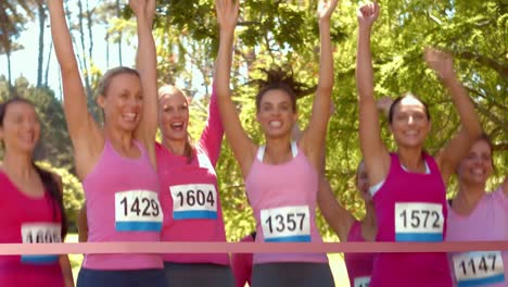 in high quality format smiling women running for breast cancer awareness