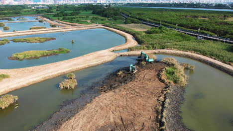 aerial shot of excavators restoring a wetland nature park