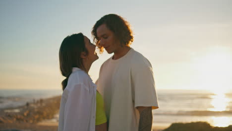 couple kissing on the beach at sunset