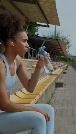 woman taking a break from exercise at stadium