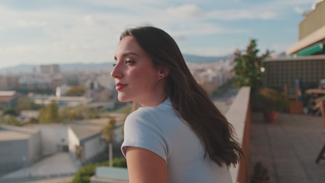 Woman Enjoying the City View from Balcony