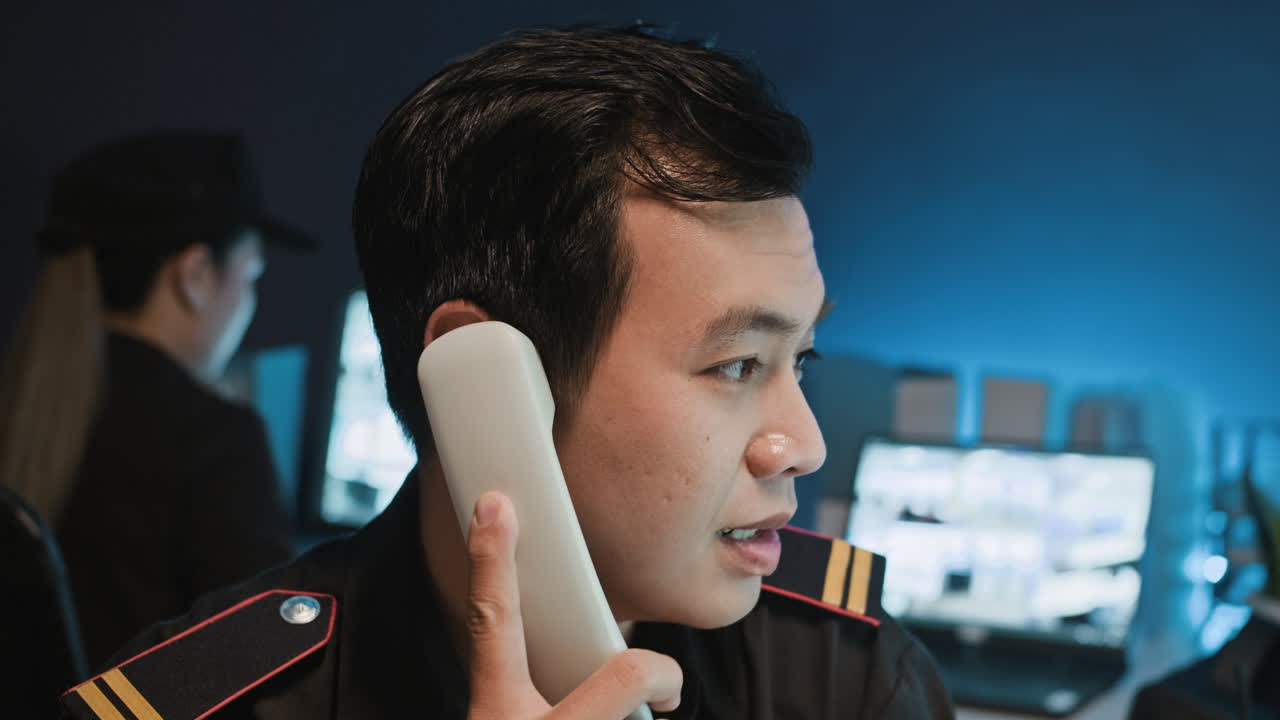 Guard Manager Talking on Landline Phone at Work