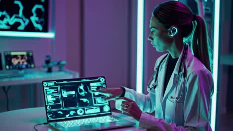 female doctor working on a futuristic laptop in a neon-lit medical lab