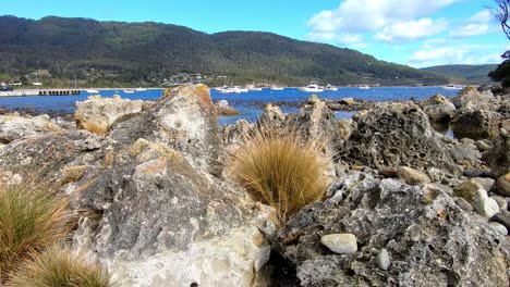 Port-Arthur,-Tasmania,-Australia---12-March-2019:-Pirates-Bay-on-the-Tasman-Peninsula-with-rocks-and-boats-moored-in-the-bay