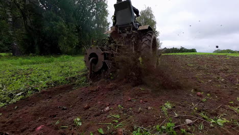 Slow-motion-clip-of-a-tractor-excavated-potato-from-the-field-for-the-further-processing