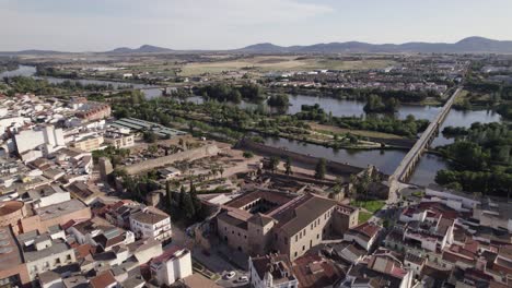 aerial: roman bridge of mérida and guadiana river in spanish cityscape