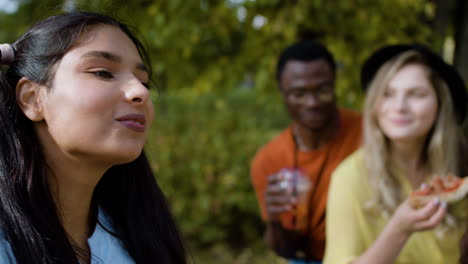 close-up of woman eating with her friends