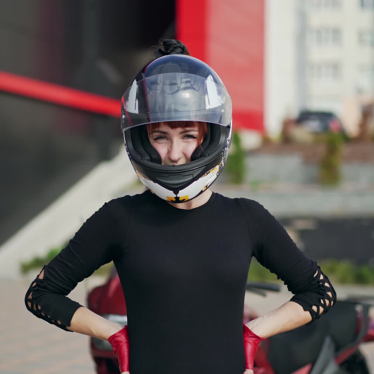 . Biker sexy woman. Young beautiful redhead motocyclist woman wearing moto helmet