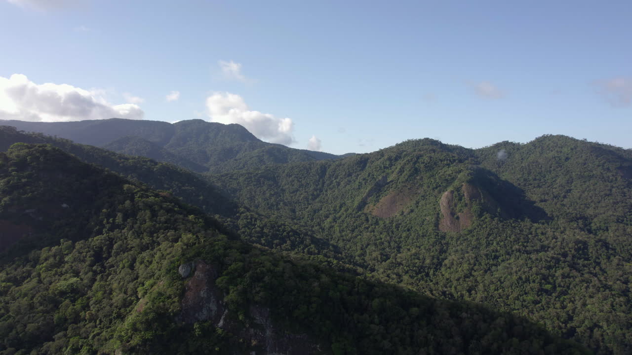 Aerial view of layered mountains, in sunny Costa Verde, Brazil - tracking, drone shot