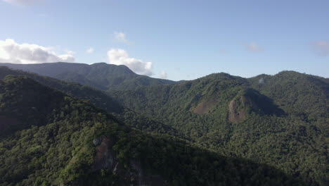 aerial view of layered mountains, in sunny costa verde, brazil - tracking, drone shot