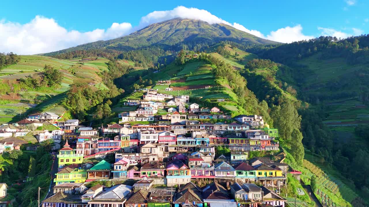 Beautiful aerial panorama of Nepal van Java village in Central Java, Indonesia. The colorful hillside settlement sits beneath Mount Sumbing, surrounded by terraced fields and misty mountains
