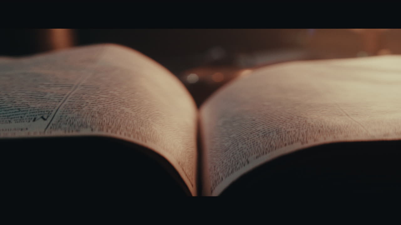 An someone turn pages of an old book inside the sailing ship cabin