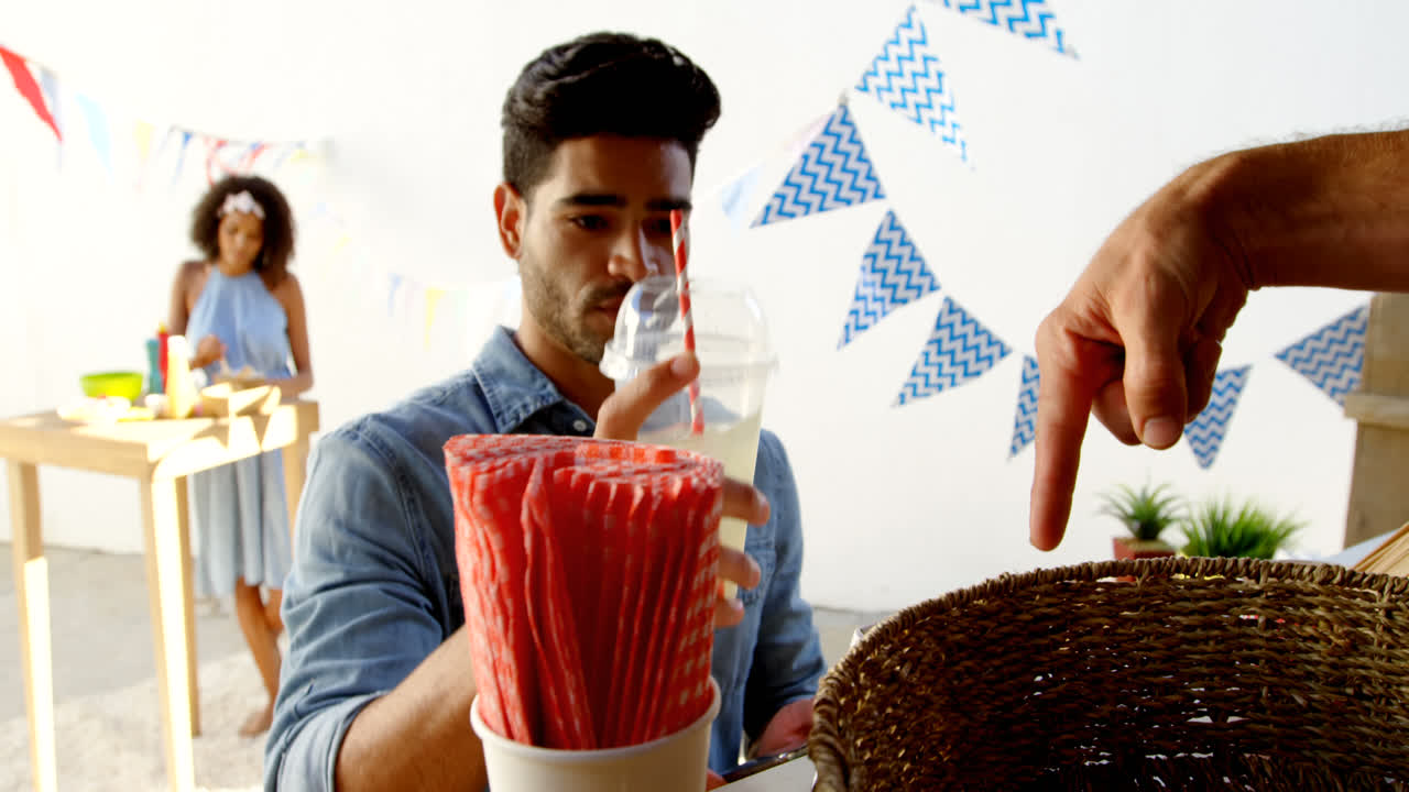 Cameriere che serve succo a un cliente al bancone