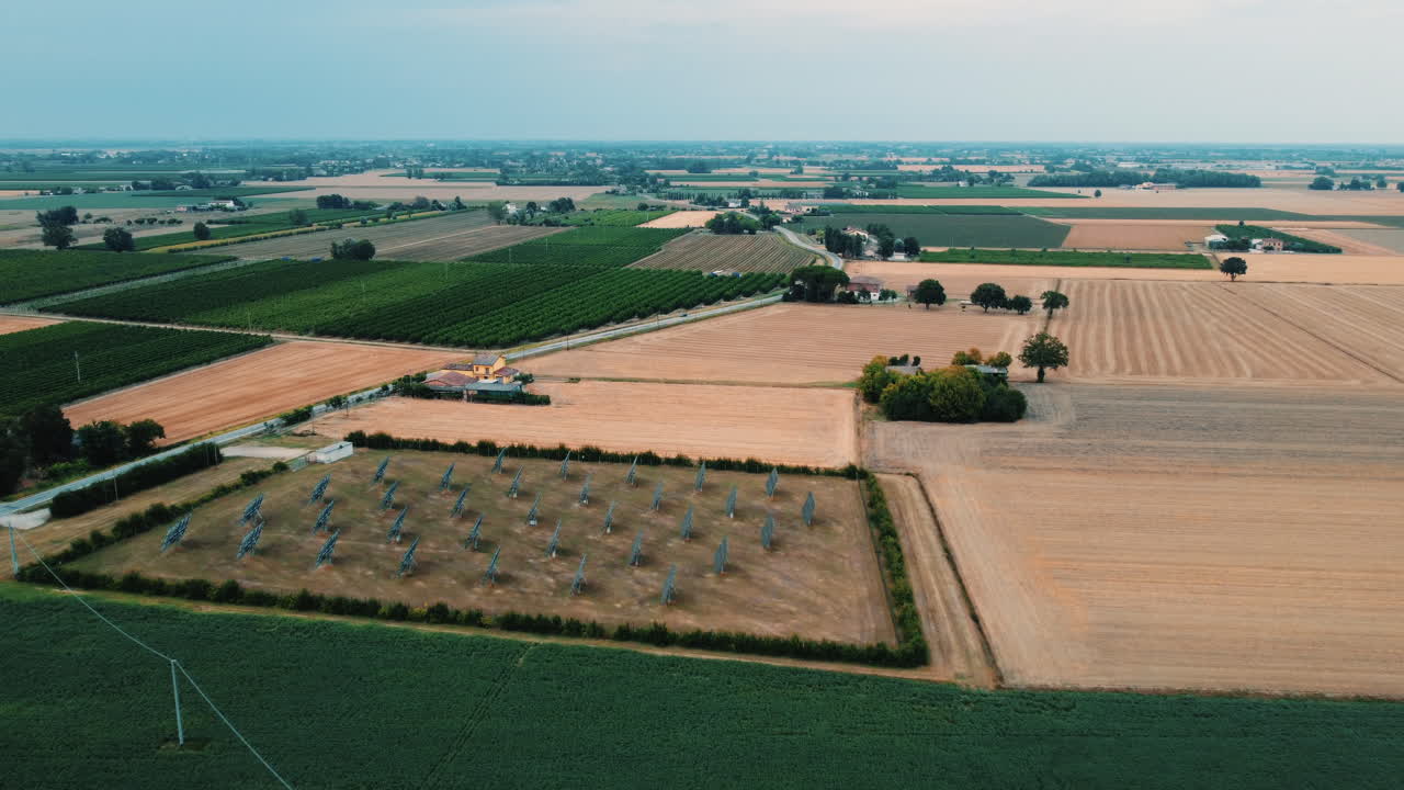 Aerial view of agricultural fields and a solar thermal power plant