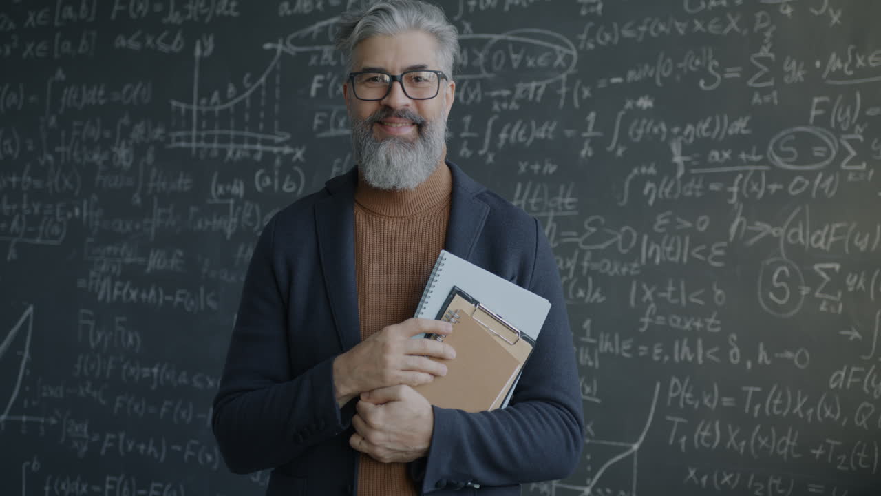 Teacher in front of a blackboard filled with equations