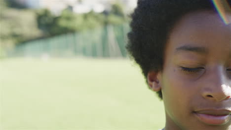 Close-up-of-a-biracial-boy-outdoors,-with-copy-space