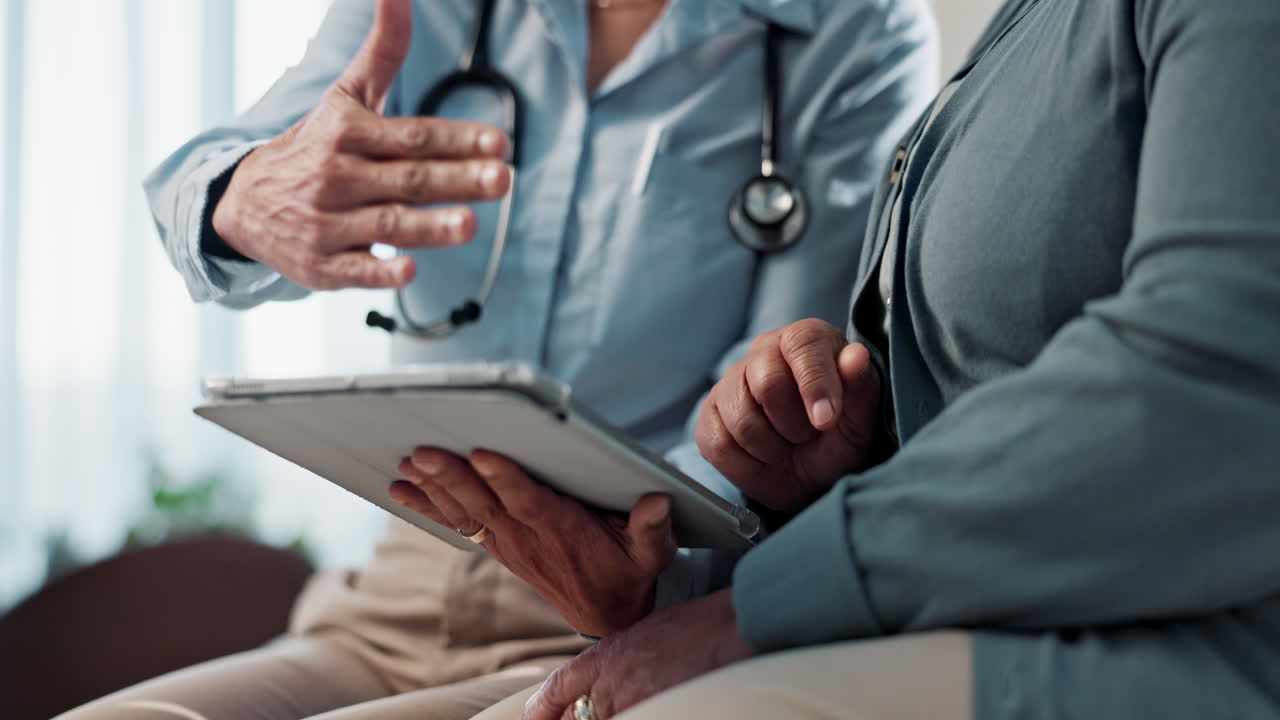 Doctor and patient reviewing medical information on a tablet