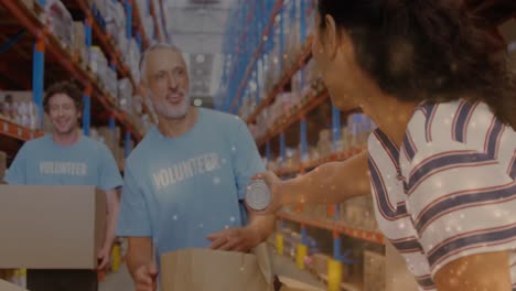 animation of glowing spots of light over diverse people carrying box working in warehouse,