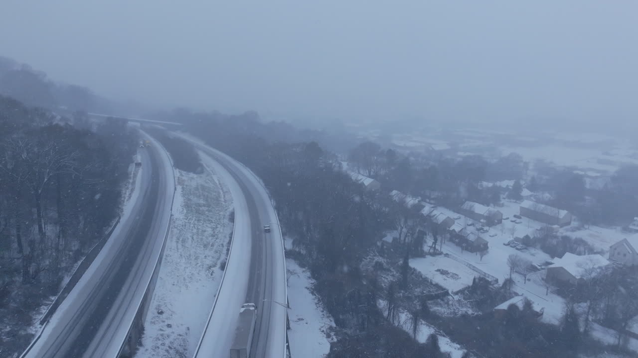 Aerial video flying over a highway during a snowstorm in Chattanooga, TN.