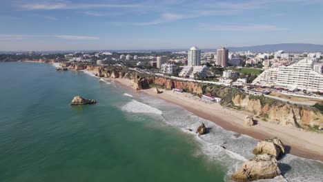 establishing aerial of beautiful long beach of praia dos tres castelos in portimao