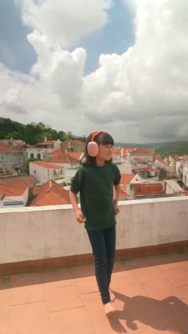 child enjoying music on rooftop