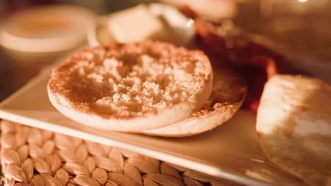 freshly toasted english muffin: close-up, breakfast plate, warm lighting