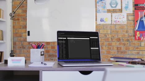 Laptop-with-data-processing-standing-on-desk-in-office