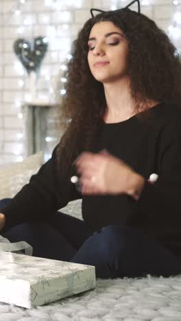 young woman opening a christmas gift