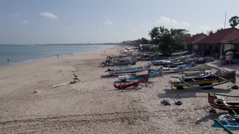 aerial video on jimbaran beach at bali, denpasar, indonesia during a sunny day with calming sea waves