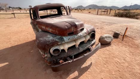 very old rusted car in the namibian desert near solitaire