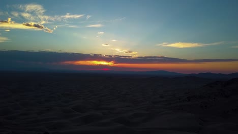 Beautiful-vivid-aerial-view-from-a-drone-of-a-sunset-looking-out-at-many-sand-dunes-in-the-Little-Sahara-desert-in-Joab-Utah