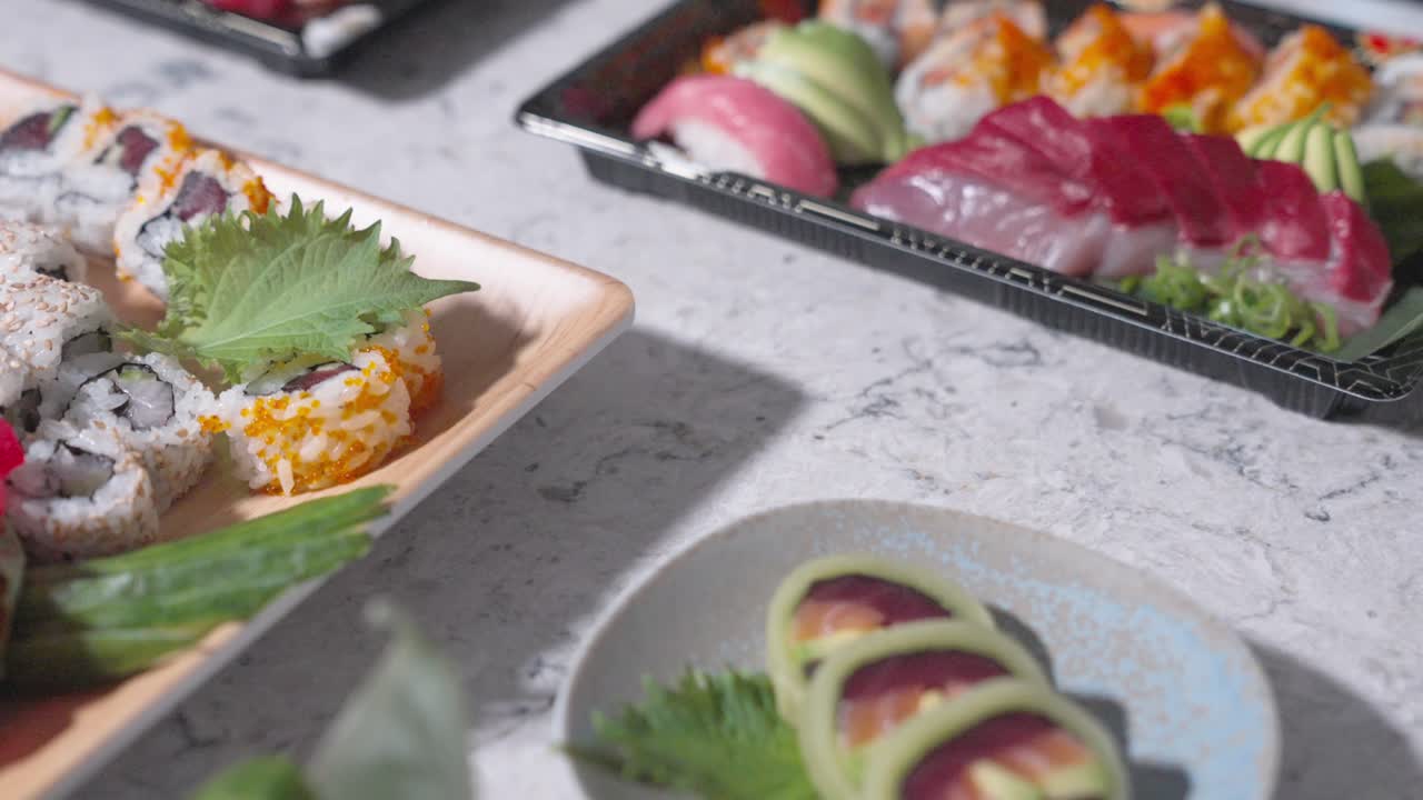 A roaming shot featuring a variety of sushi rolls, showcasing different types and assortments. Perfect for highlighting Japanese cuisine, sushi variety, and food presentation.