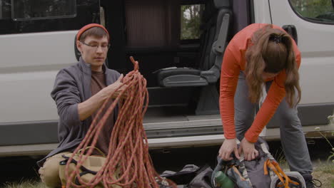 caucasian couple next to their van